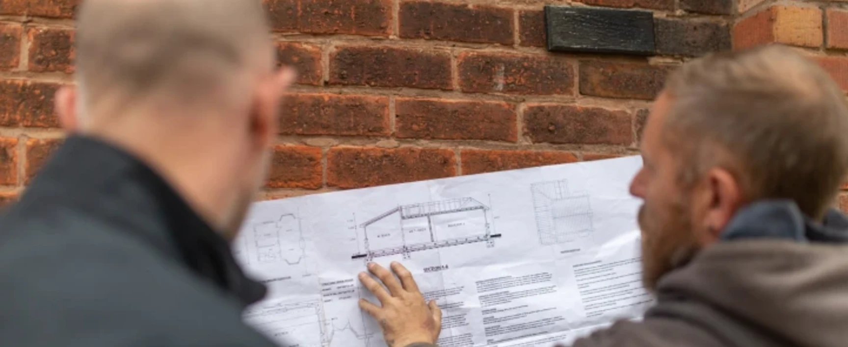 A Building Inspector and Builder Reviewing a Plan