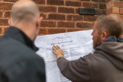 A Building Inspector and Builder Reviewing a Plan